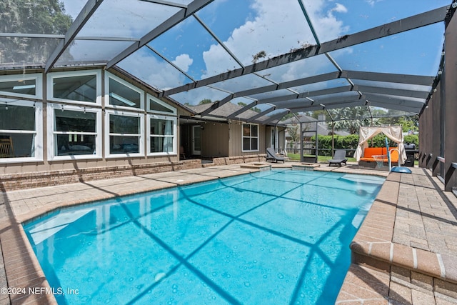 pool with a lanai and a patio area