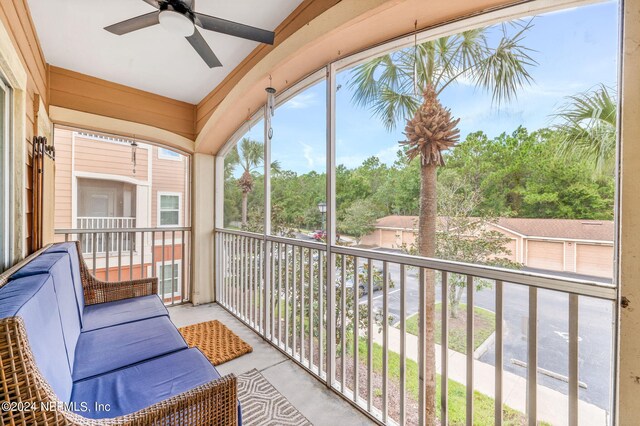 sunroom with lofted ceiling and ceiling fan