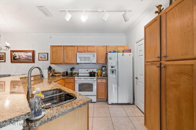 kitchen featuring light tile patterned floors, white appliances, light stone counters, sink, and ornamental molding