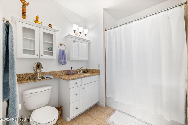 full bathroom featuring tile patterned floors, toilet, shower / tub combo, and vanity