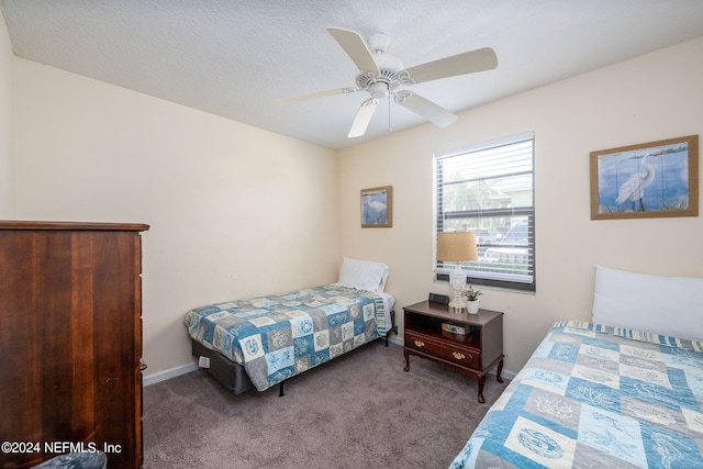 carpeted bedroom with ceiling fan and a textured ceiling