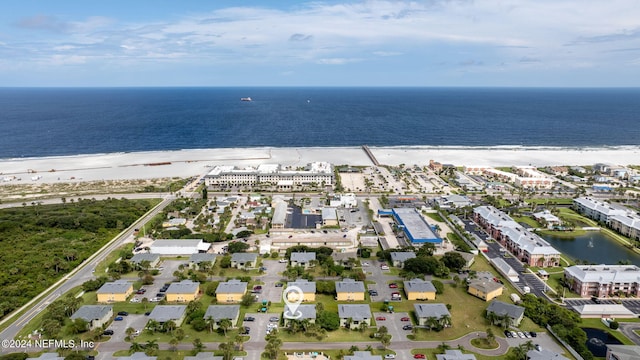 birds eye view of property with a beach view and a water view