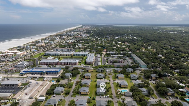 birds eye view of property with a water view and a view of the beach