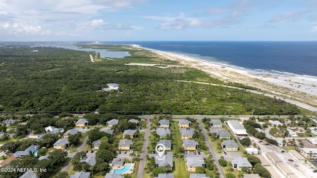 birds eye view of property with a water view and a beach view