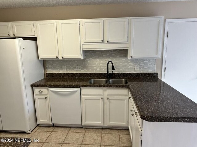 kitchen featuring white cabinets, white appliances, light tile patterned flooring, and sink