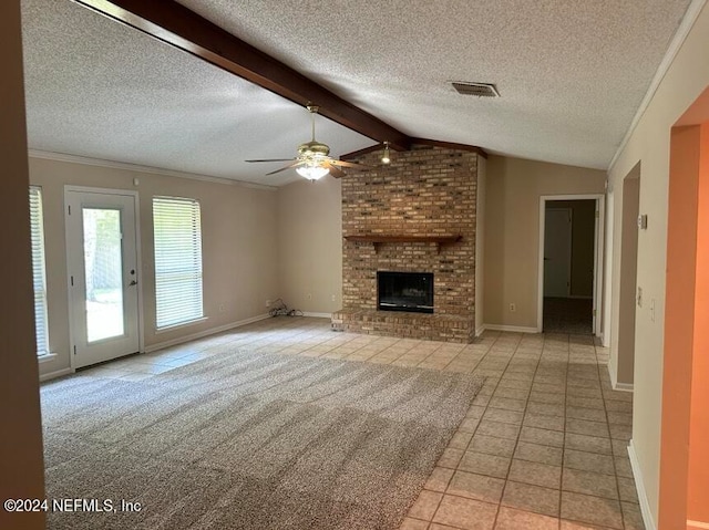 unfurnished living room with a fireplace, light carpet, brick wall, ceiling fan, and vaulted ceiling with beams