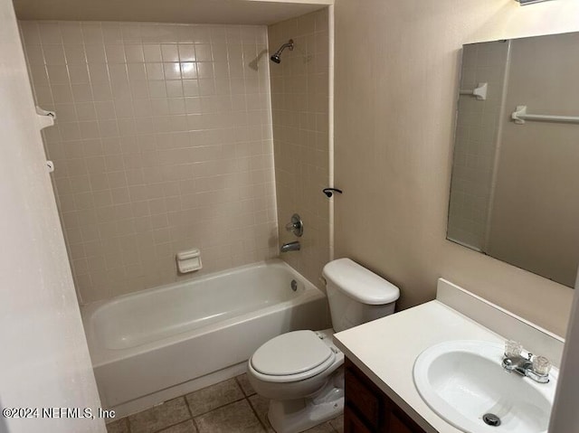 full bathroom featuring vanity, toilet, tiled shower / bath combo, and tile patterned floors