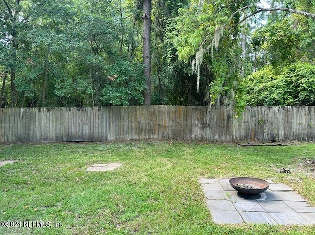 view of yard with an outdoor fire pit