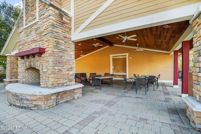 view of patio / terrace featuring an outdoor living space with a fireplace and ceiling fan