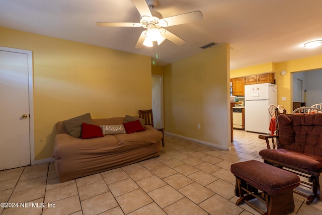 living room with light tile patterned flooring, baseboards, visible vents, and ceiling fan