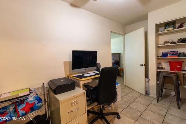 office area with light tile patterned floors and a textured ceiling