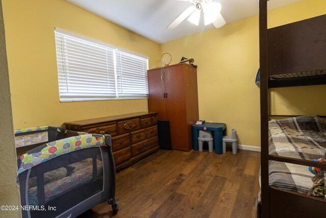 bedroom with baseboards, wood finished floors, and a ceiling fan