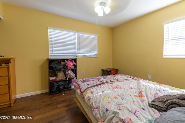 bedroom featuring wood finished floors and baseboards