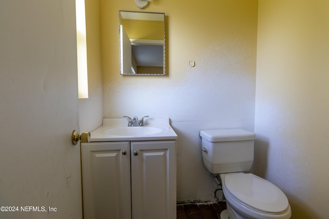 bathroom featuring toilet and vanity