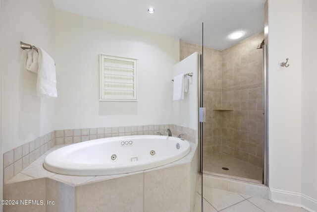 bathroom with plus walk in shower and tile patterned flooring