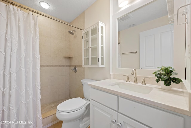 bathroom with a shower with shower curtain, toilet, a textured ceiling, and vanity