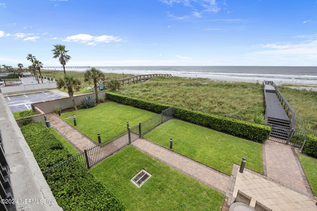 bird's eye view with a water view and a beach view