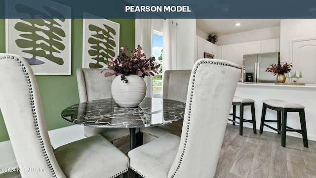 dining room featuring light wood-type flooring and recessed lighting