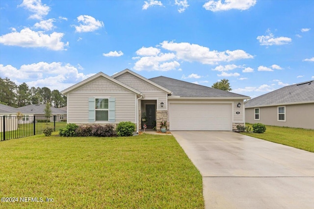 view of front of house featuring a garage and a front lawn