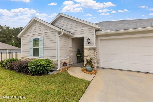 view of front of property featuring a garage and a front lawn