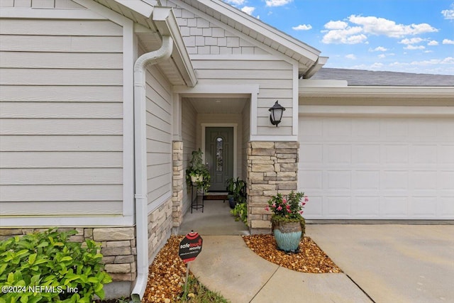 doorway to property with a garage