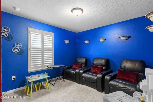 carpeted home theater featuring a textured ceiling