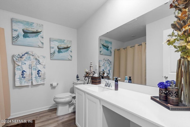 bathroom featuring vanity, toilet, a shower with curtain, and wood-type flooring