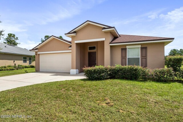 view of front of house featuring a garage and a front yard