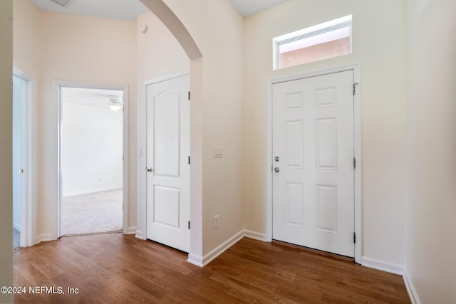 foyer entrance with ceiling fan and dark hardwood / wood-style floors