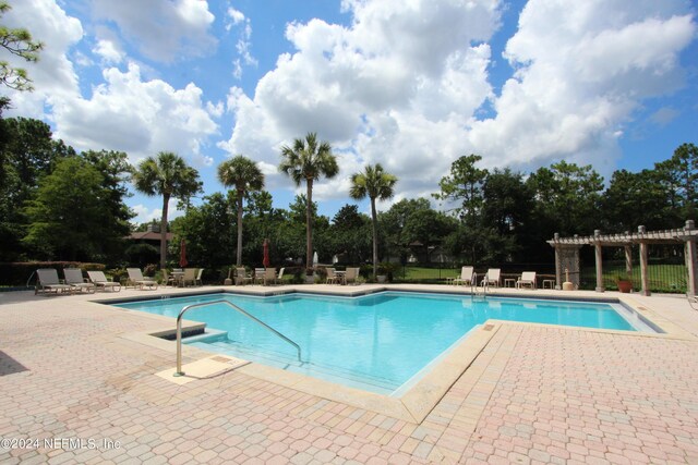 view of pool featuring a patio and a pergola