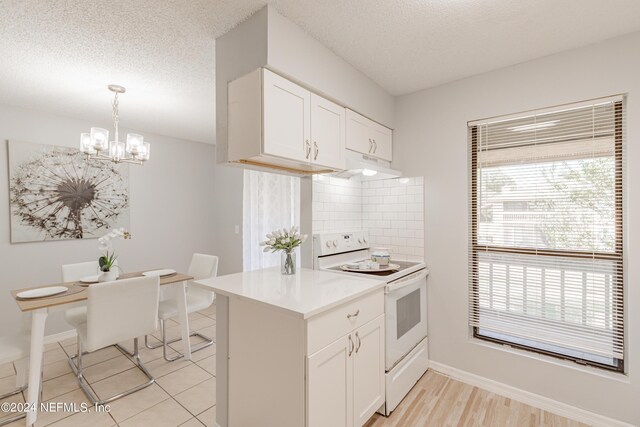 kitchen featuring white cabinetry, backsplash, decorative light fixtures, and white electric range oven