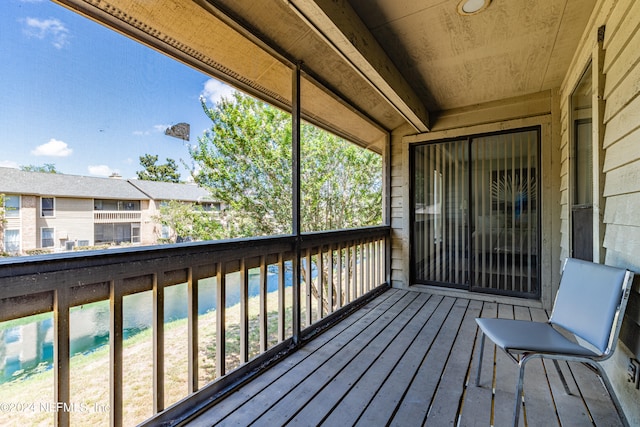 wooden deck featuring a water view