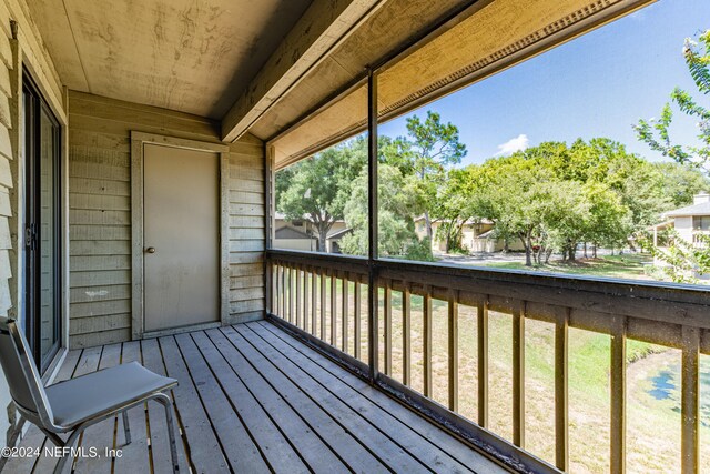 wooden terrace featuring a yard