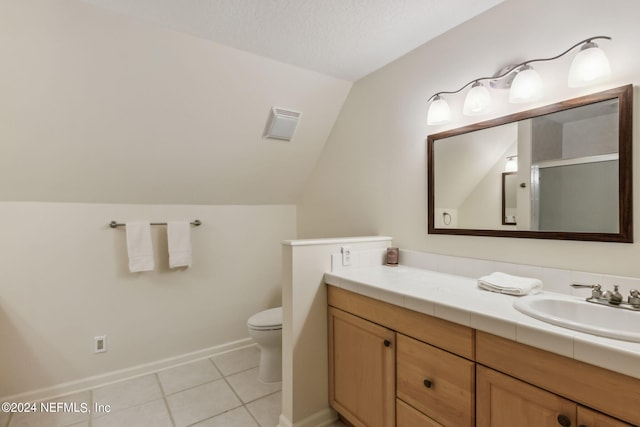 bathroom with vaulted ceiling, vanity, tile patterned flooring, toilet, and an enclosed shower