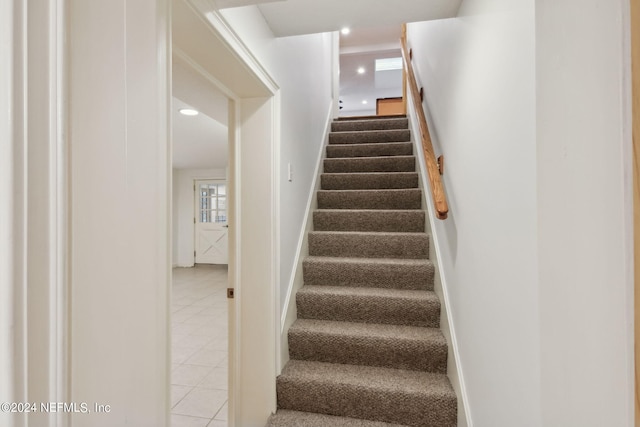 staircase featuring tile patterned floors