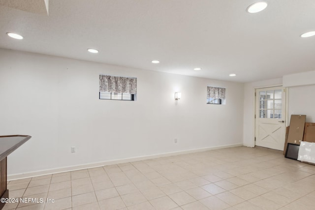 interior space with light tile patterned floors and a healthy amount of sunlight