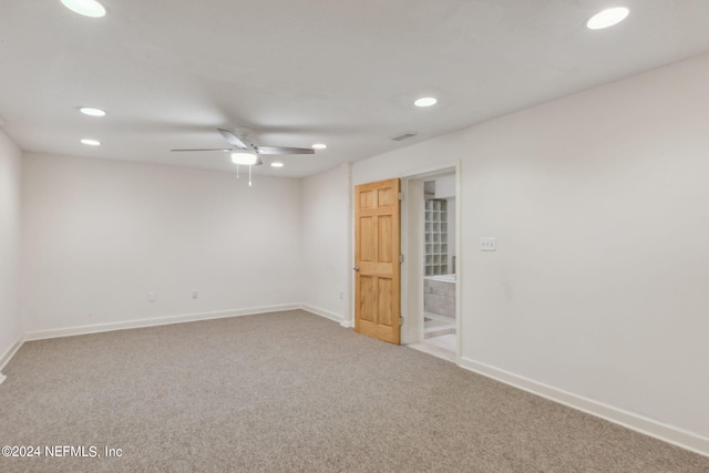 carpeted spare room with ceiling fan