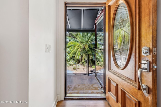 doorway to outside featuring a healthy amount of sunlight and wood finished floors