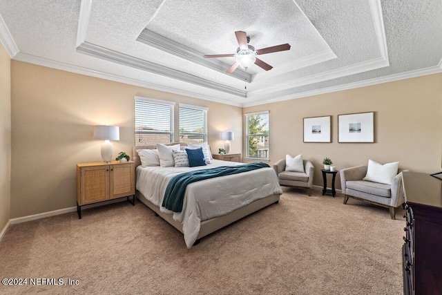 carpeted bedroom featuring a tray ceiling, crown molding, ceiling fan, and a textured ceiling