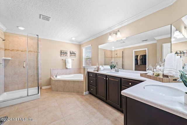 bathroom with a textured ceiling, vanity, ornamental molding, and independent shower and bath