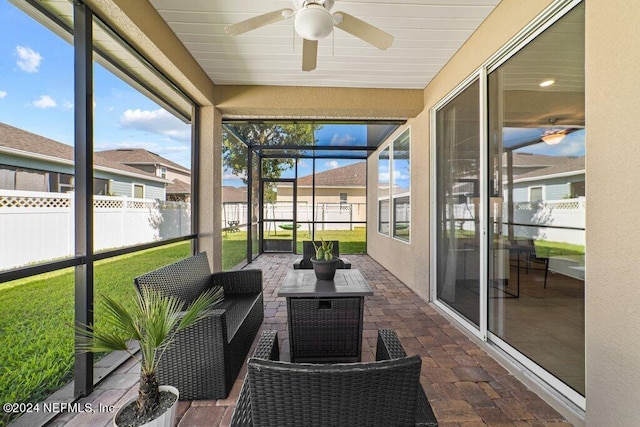 sunroom featuring ceiling fan