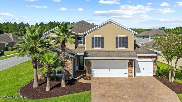 view of front of home featuring a front yard and a garage