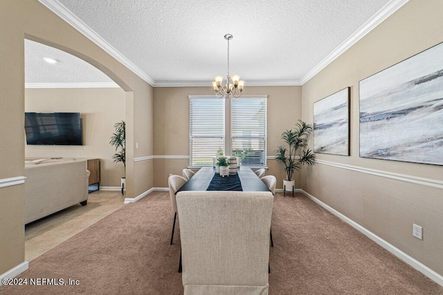 carpeted dining room with ornamental molding, a textured ceiling, and a chandelier