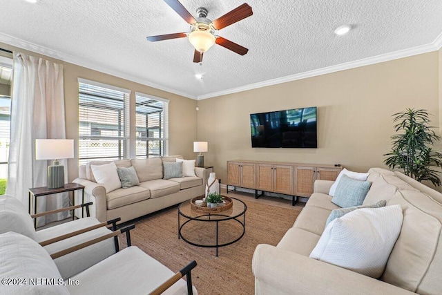 living room featuring a textured ceiling, ceiling fan, and ornamental molding