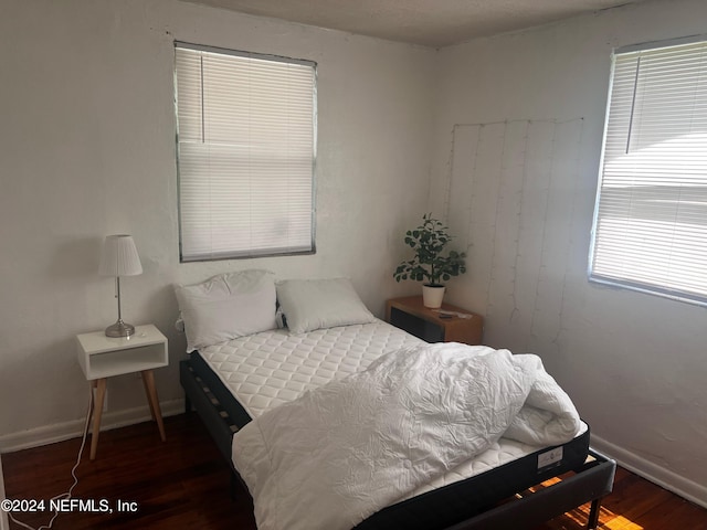 bedroom featuring dark hardwood / wood-style flooring