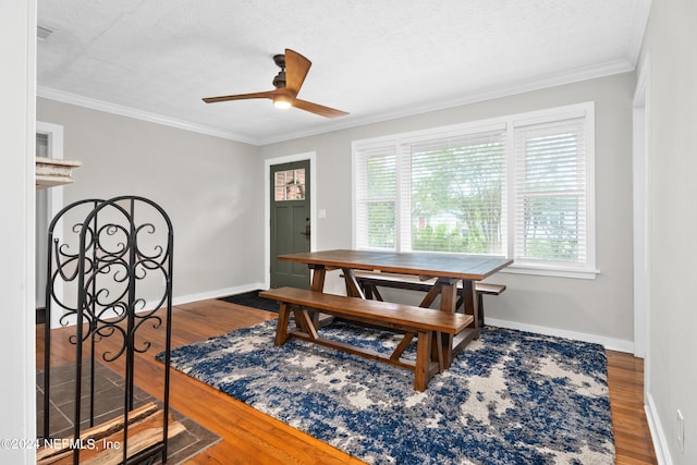 interior space featuring ceiling fan, dark hardwood / wood-style floors, crown molding, and a textured ceiling