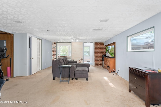 carpeted dining room with a textured ceiling and brick wall