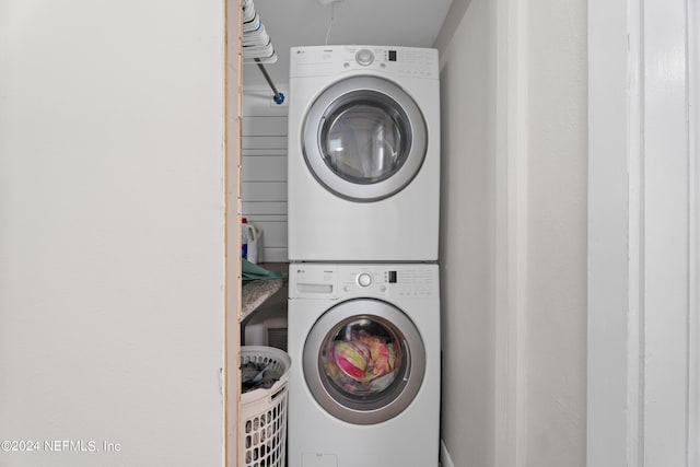 laundry room with stacked washer and dryer