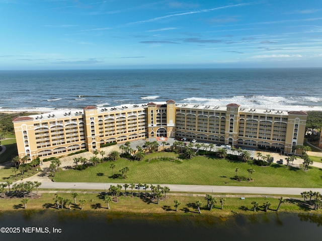 bird's eye view featuring a water view and a beach view