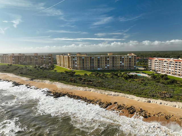 drone / aerial view with a water view and a beach view